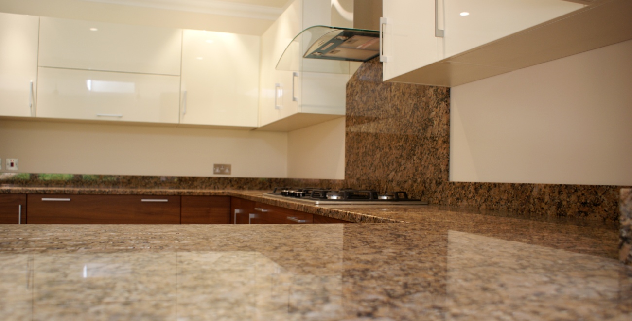 Brown granite kitchen worktop with upstand and splashback